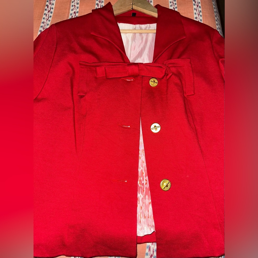 Red blazer with bow and gold accents